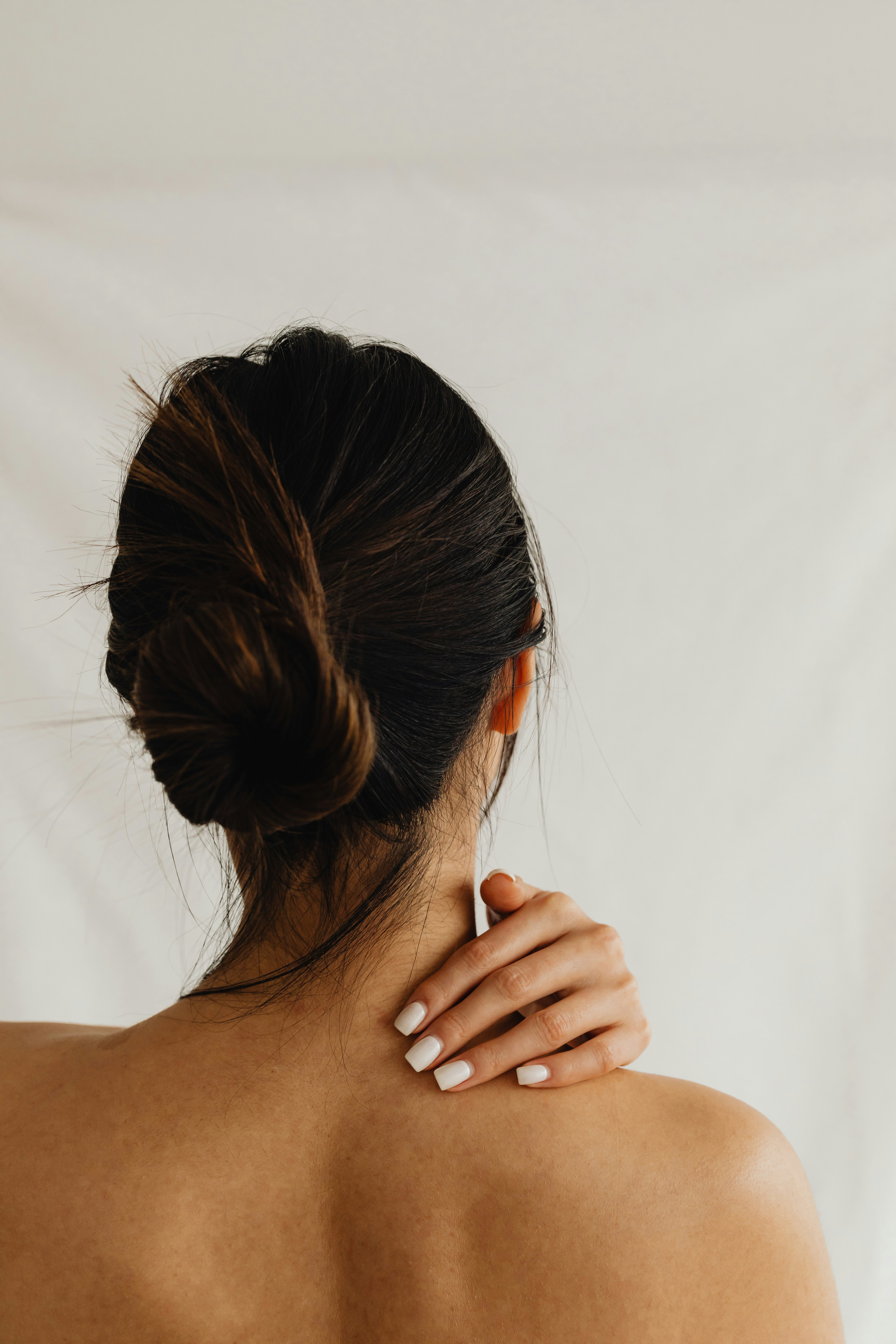 woman touching her neck
